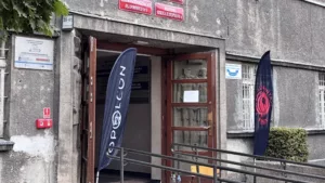 Entrance of a vocational school featuring banners and signage, with a ramp for accessibility.